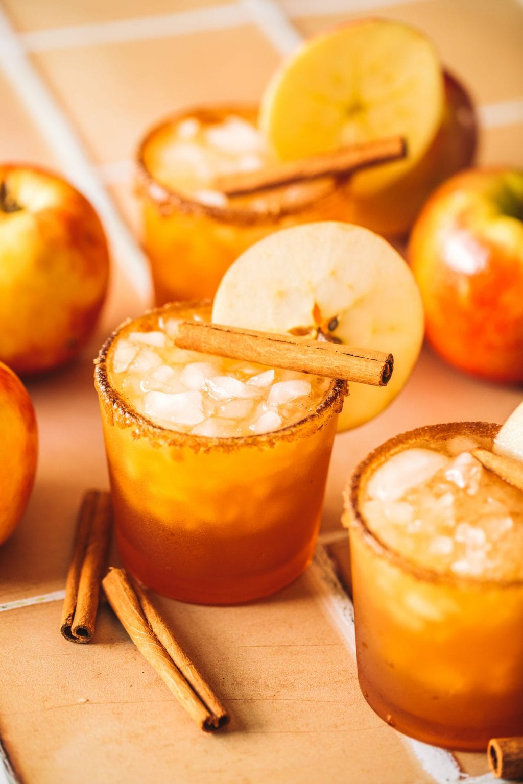 apple cider margaritas in glasses with apple slice garnish