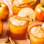 apple cider margaritas in glasses with apple slice garnish