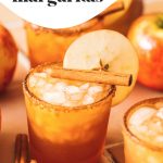 apple cider margaritas in glasses with apple slice garnish