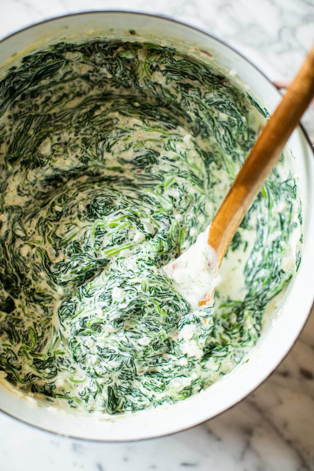 creamed spinach in pot with spatula