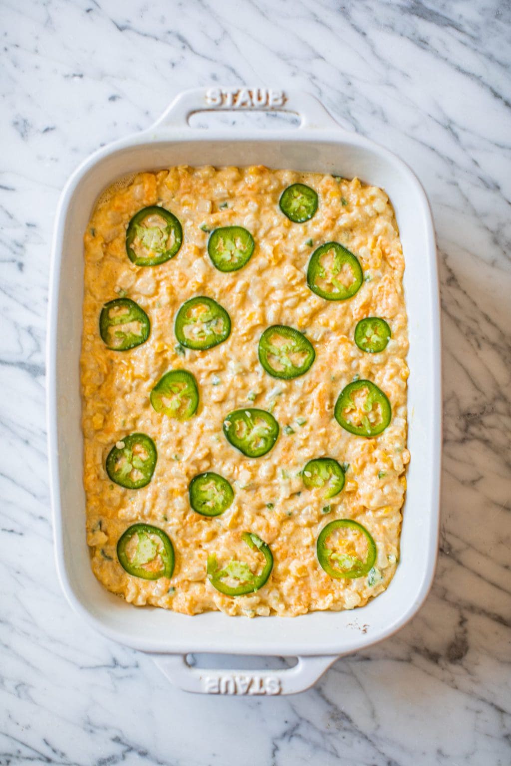 jalapeno cornbread casserole batter in white casserole dish