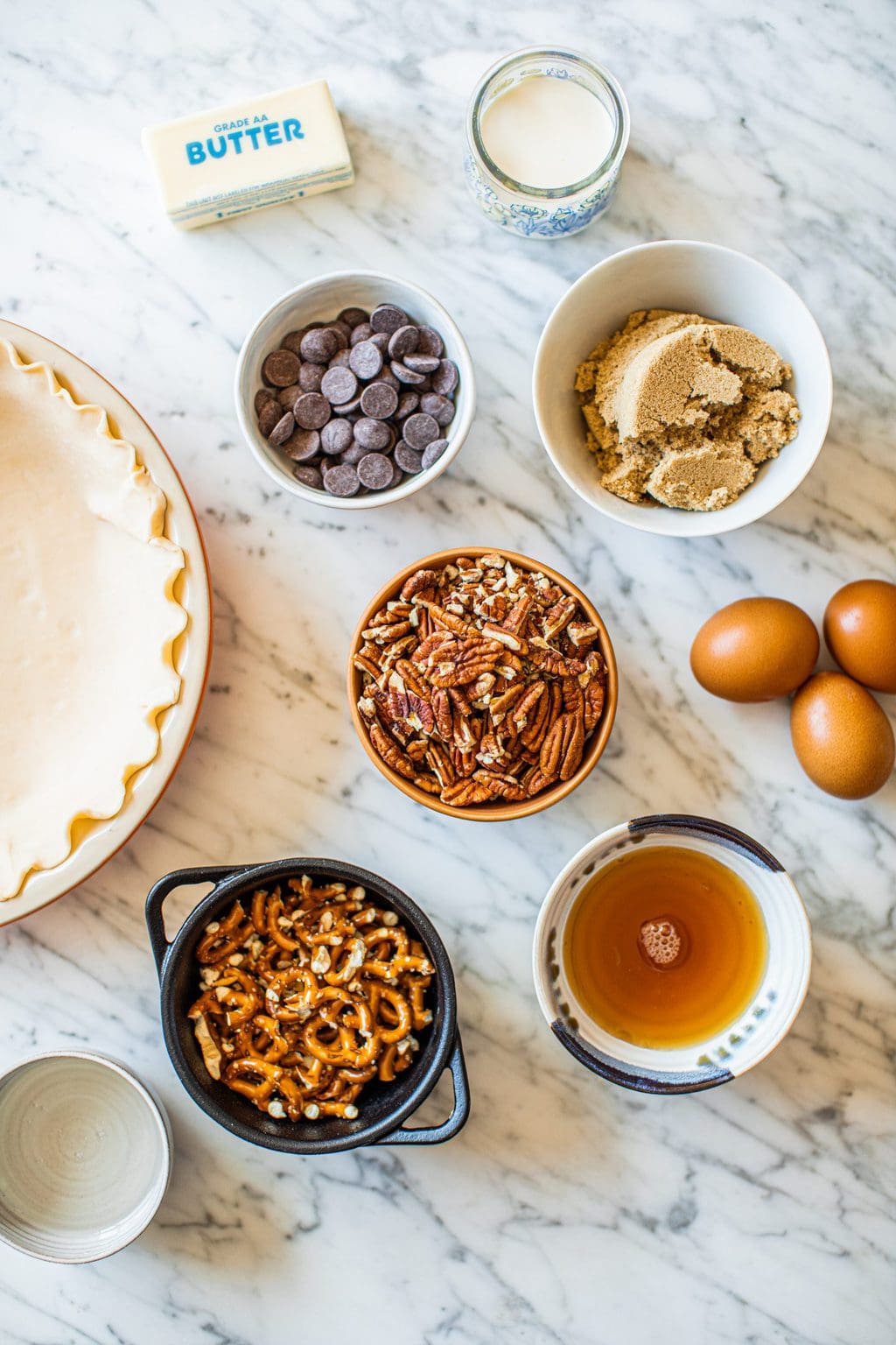 pie dough, chocolate chips, brown sugar, eggs, pecans, pretzels, maple syrup