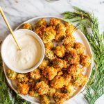 deep fried olives stuffed with blue cheese on white platter with aioli