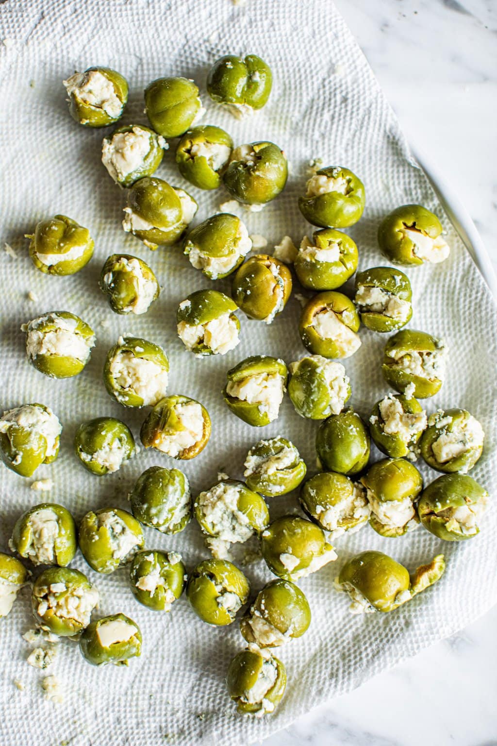 green olives stuffed with blue cheese on paper towels