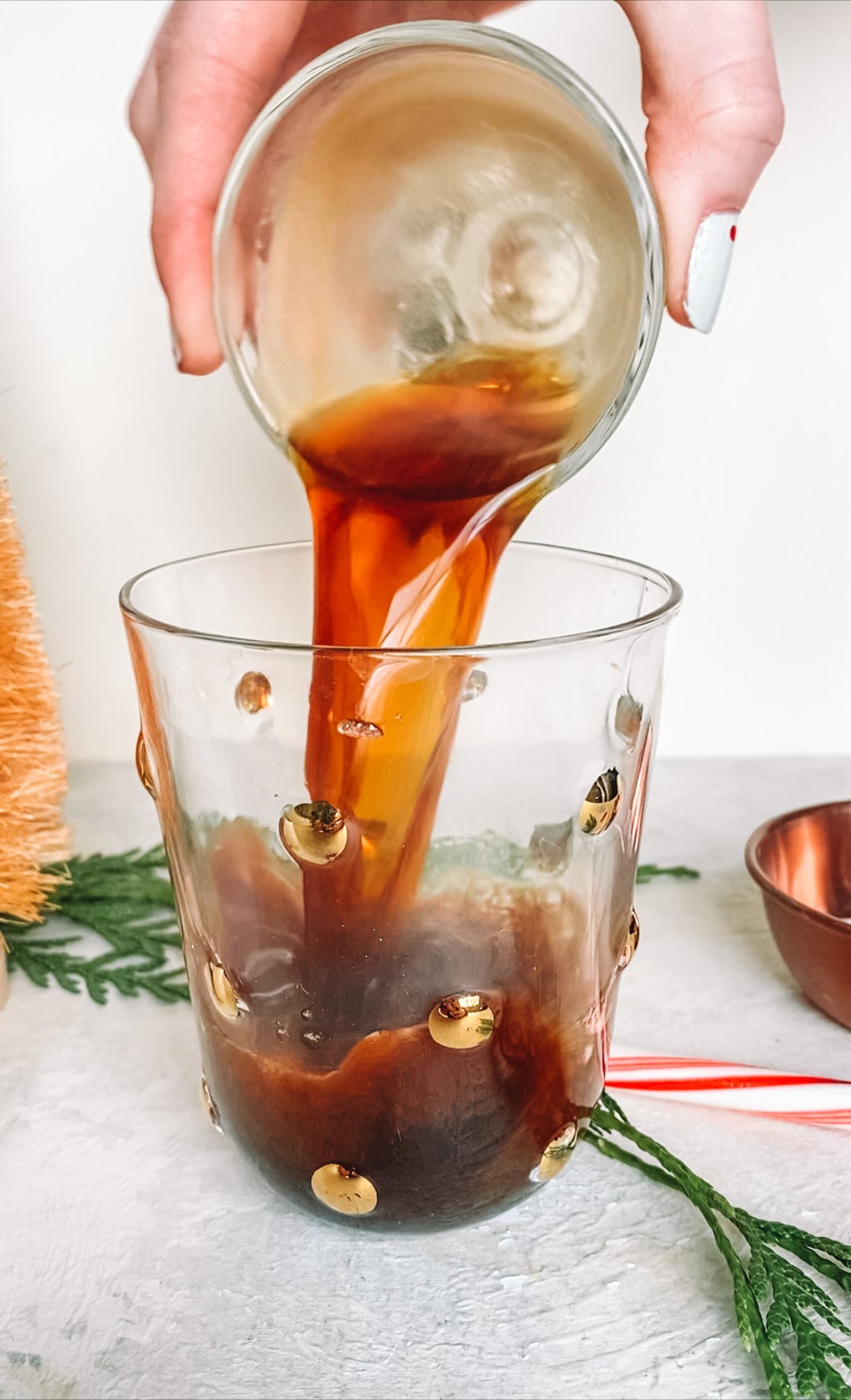 Fresh espresso being poured into a small glass. 