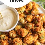 deep fried stuffed olives on white platter with aioli in bowl