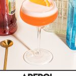 gin aperol cocktail in coupe glass garnished with orange