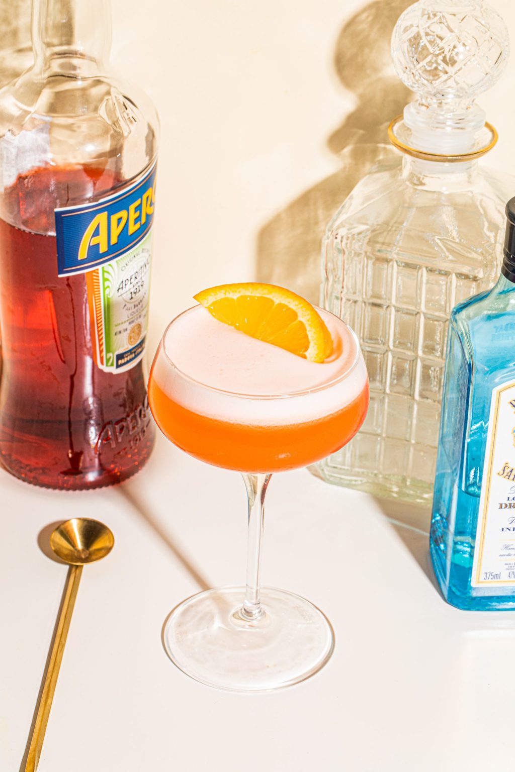 gin and aperol cocktail garnished with orange slice