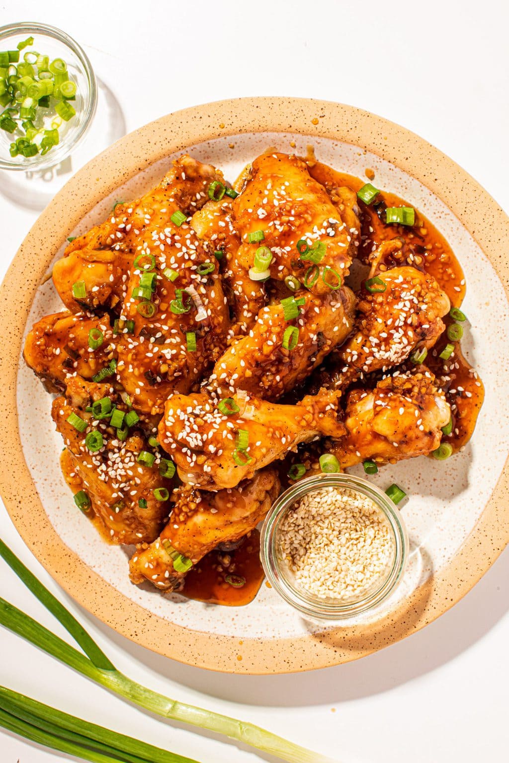 chicken wings on a cream plate with one wing being grabbed