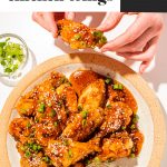 honey soy garlic chicken wings on a cream plate with a side of sesame seeds