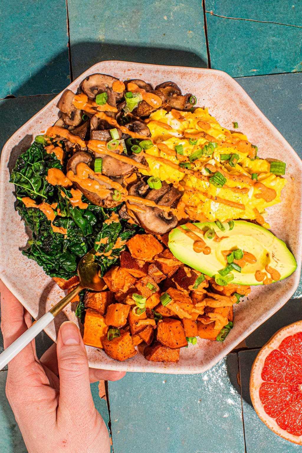 savory sweet potato breakfast recipe in pink bowl with chipotle sauce