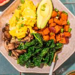 savory sweet potato breakfast bowl with eggs, kale and avocado