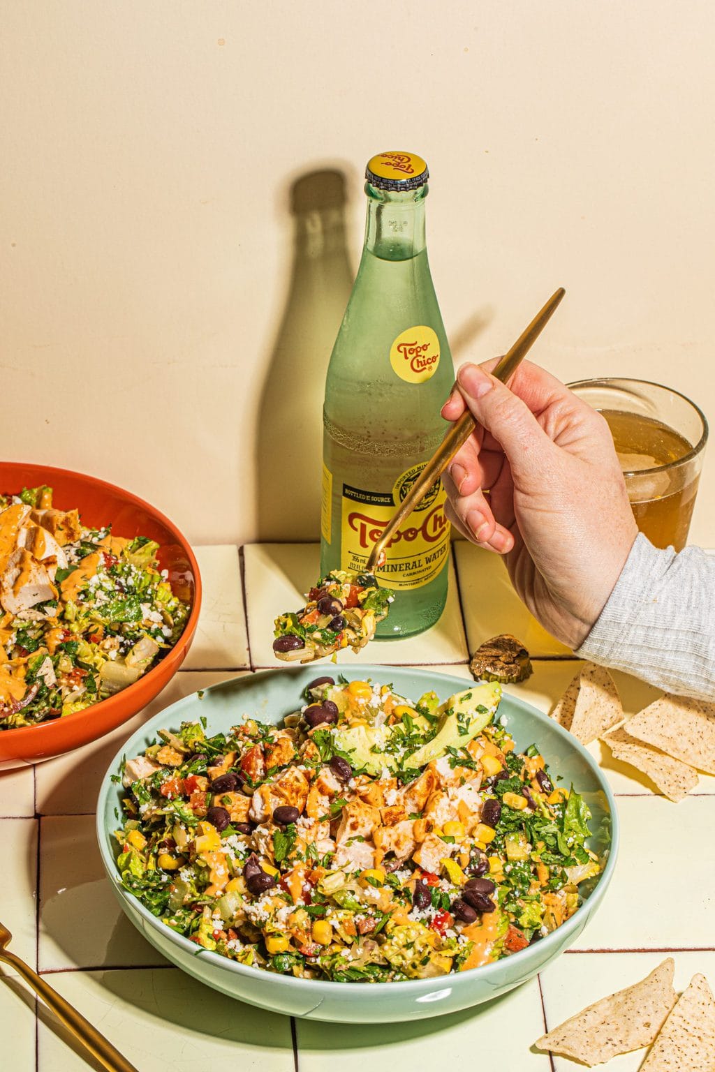 gold fork digging into large bowl of southwest salad