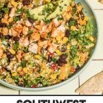 southwest chopped salad in large blue bowl with gold spoon