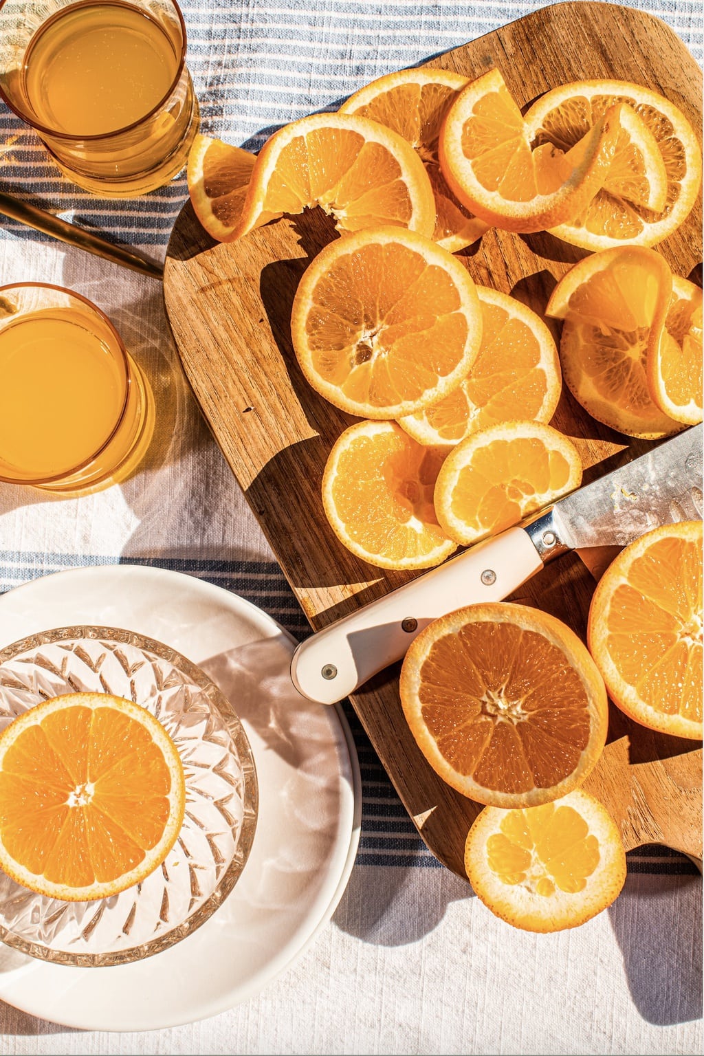 orange slices on a cutting board with a knife 