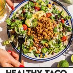 healthy turkey taco salad on large plate being eaten with fork