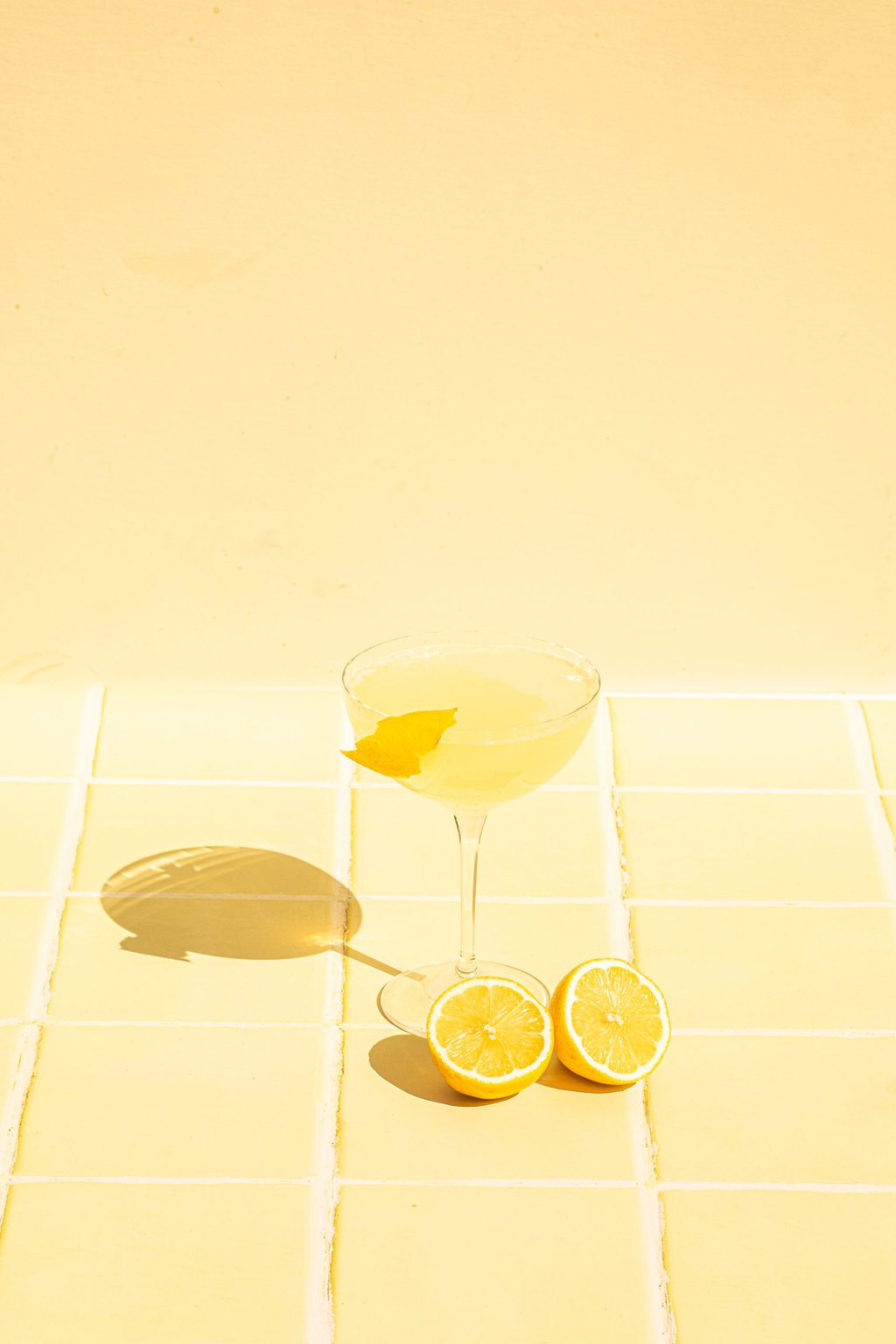 best Italian cocktail with limoncello in coupe glass with fresh lemon