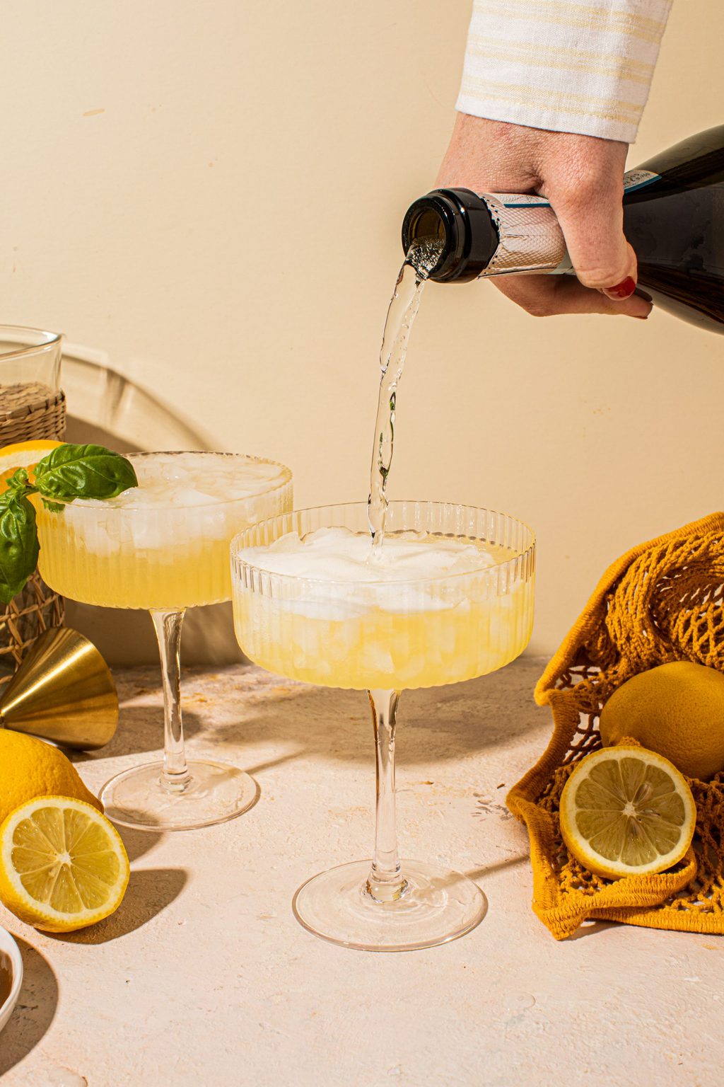 prosecco being poured into a coupe glass