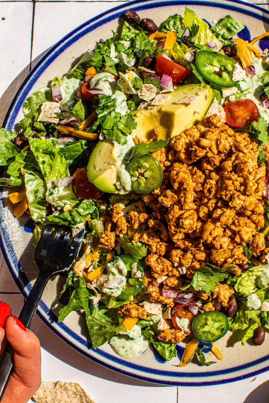 taco salad recipe on large plate with fork