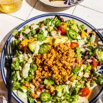 taco salad with ground turkey on large plate with fork