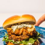 blue cheese burger with caramelized onions on blue plate