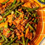 chinese chicken with string beans and garlic sauce on glass platter