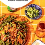 string bean chicken on large glass platter with sesame seeds on side