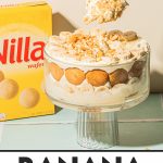 scooping a spoonful of banana pudding from trifle dish