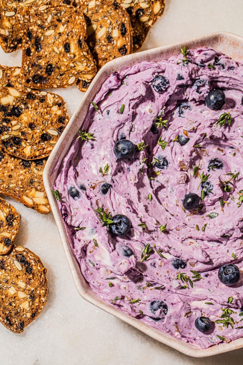 blueberry goat cheese dip in bowl with crisps on the side