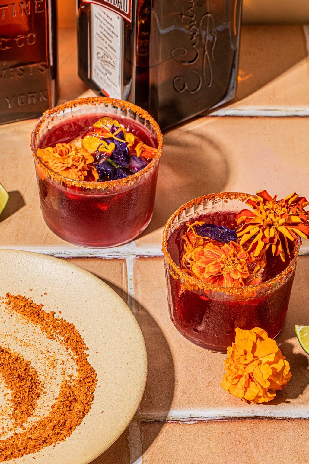 two hibiscus margaritas in glasses with tajin rim