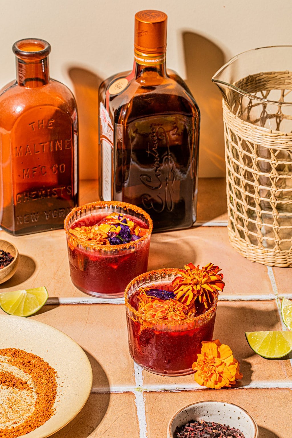 two hibiscus margaritas in glasses with tajin rim