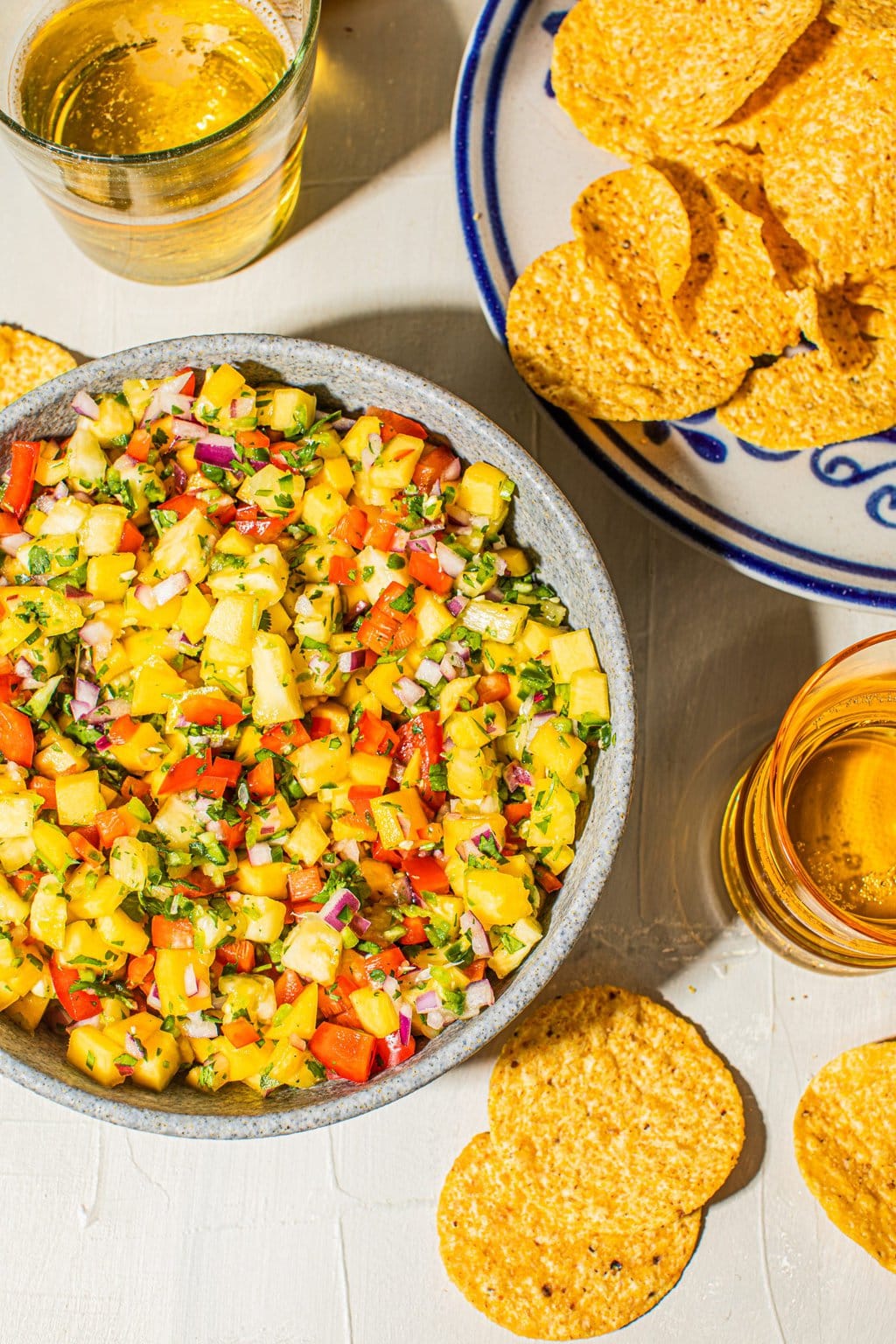 mango and pinepple salsa in serving bowl with tortilla chips on side