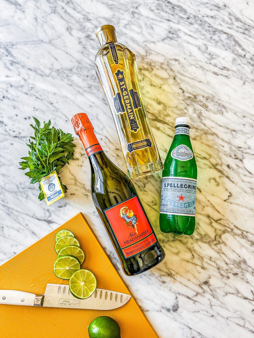 mint leaves, lime wheels, prosecco bottle, sparkling water, st germain liqueur 