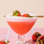 strawberry tequila sour in glass garnished with fresh strawberries