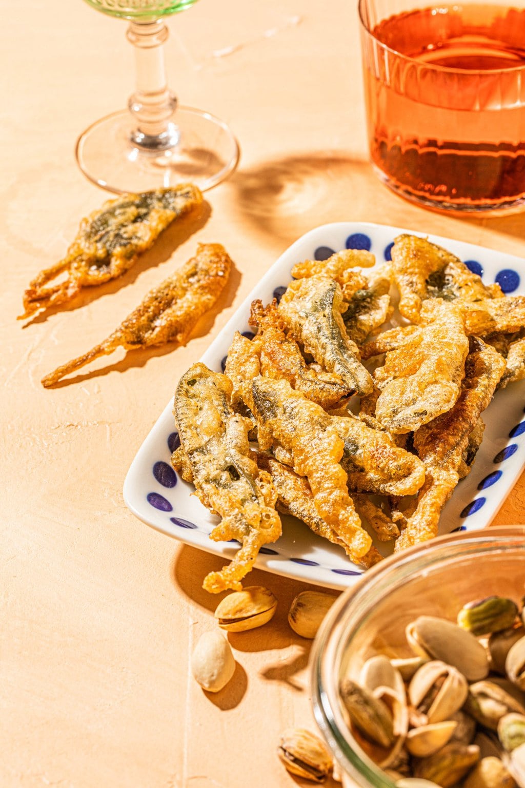 fried sage pieces on a white dish with blue polka dots