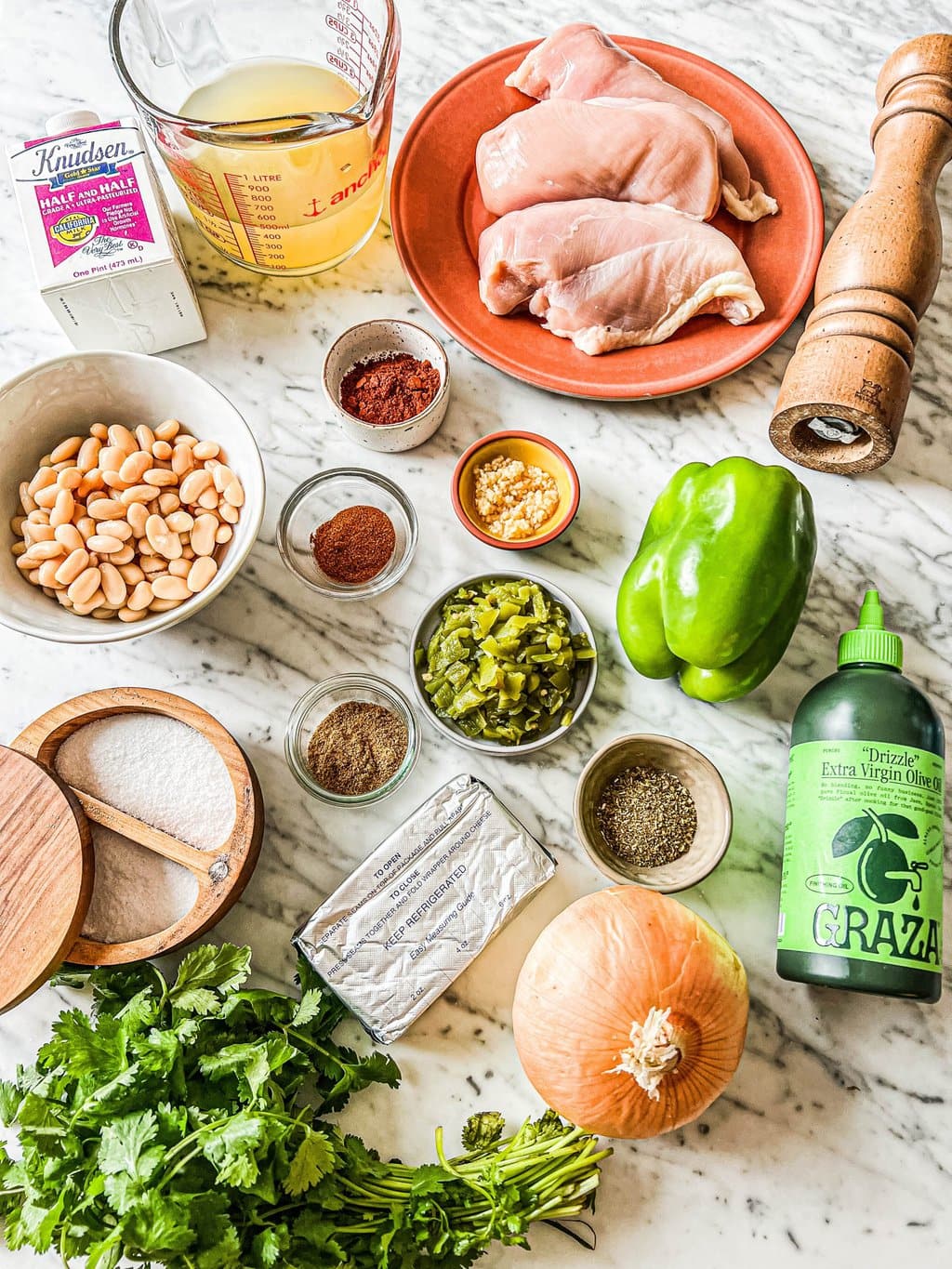 chicken breasts, chicken broth, half and half, white beans, chile powder, cumin, green chiles, green pepper, onion, cream cheese, cilantro, salt, pepper, olive oil