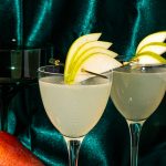 two pear martinis in glass garnished with fresh pear