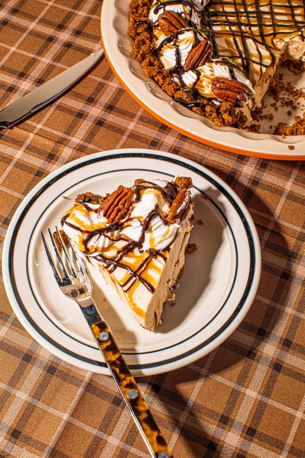 slice of caramel turtle pie on plate with fork