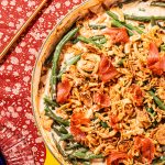 yellow casserole dish with green bean casserole and a gold spoon