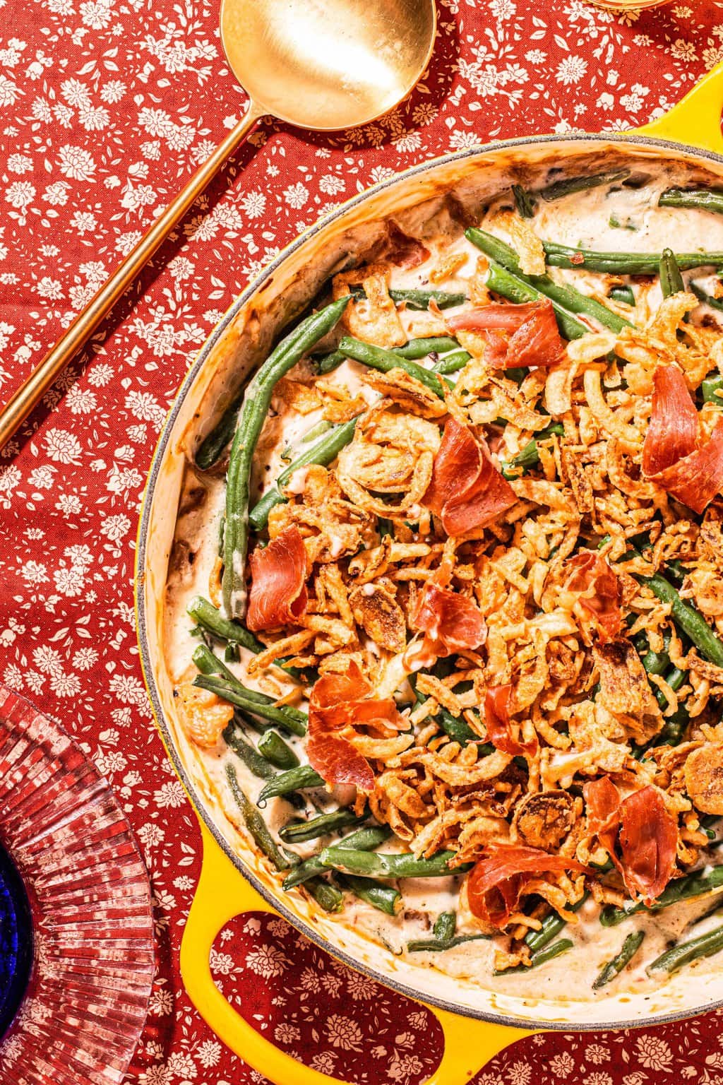 yellow casserole dish with green bean casserole and a gold spoon