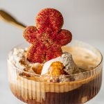 gingerbread cookie sitting on top of affogato in coupe glass