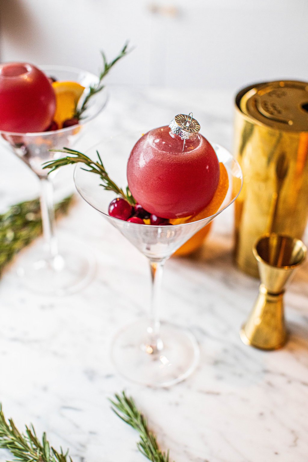 pomegranate ornament cocktail placed in martini glass