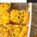 spatula lifting sausage egg bake out of white baking dish