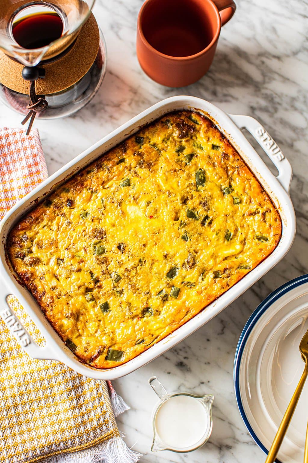 sausage egg cheese casserole in white ceramic baking dish