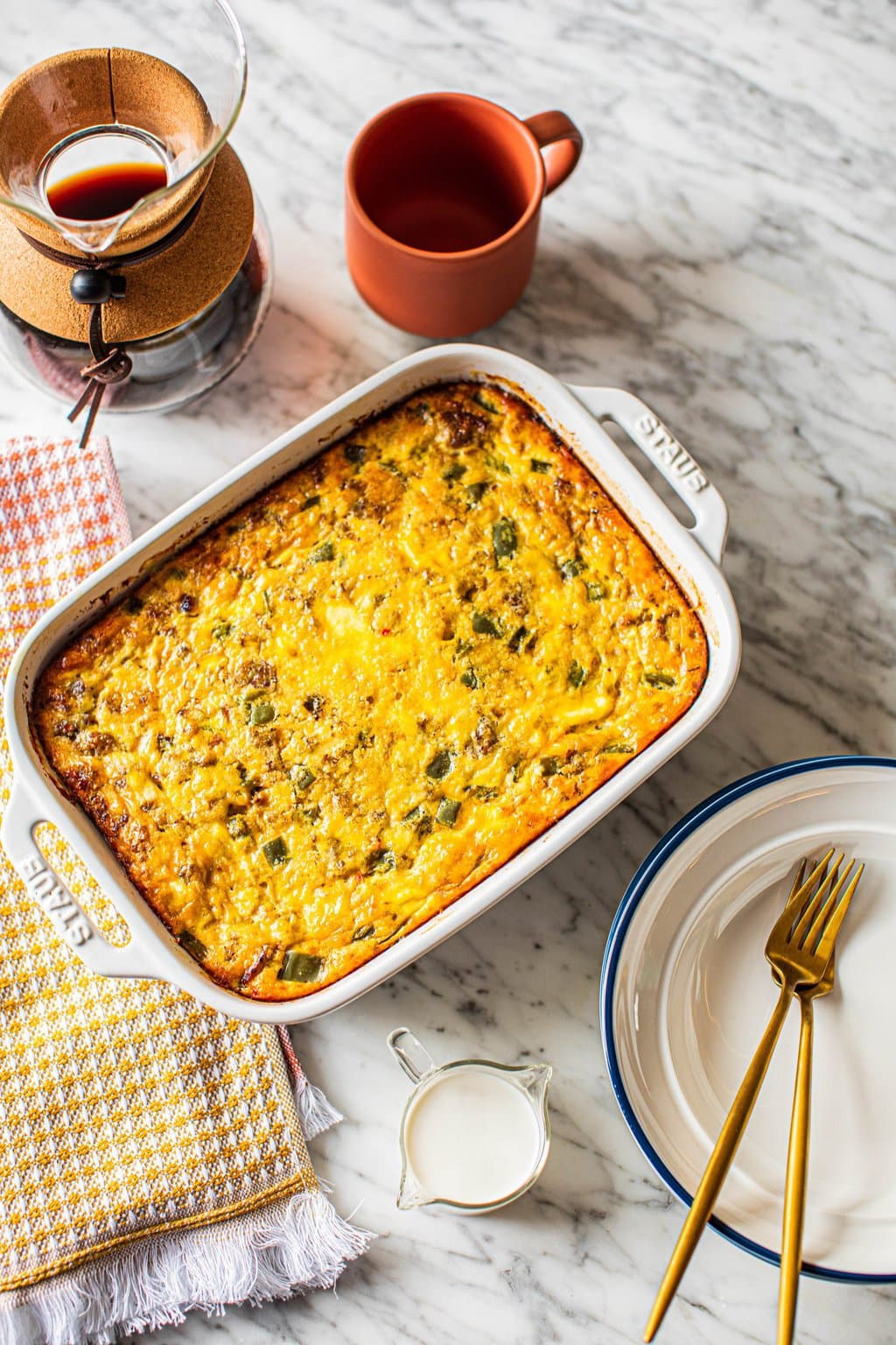 sausage egg cheese casserole in white ceramic baking dish