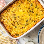 sausage egg breakfast casserole in white ceramic baking dish