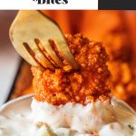 boneless buffalo wing on fork dipping into blue cheese sauce