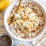 overnight oats with coconut milk in white bowl topped with banana slices