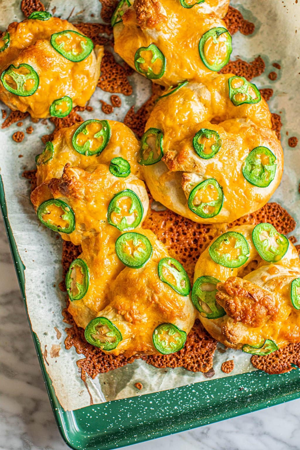 jalapeno cheese pretzels on parchment lined baking sheet