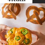 woman holding jalapeno cheddar pretzel in two hands